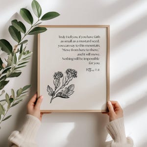 May include: A framed print with a light beige background features a botanical illustration and text. The text reads, "Truly I tell you, if you have faith as small as a mustard seed..." The frame is a light brown color.