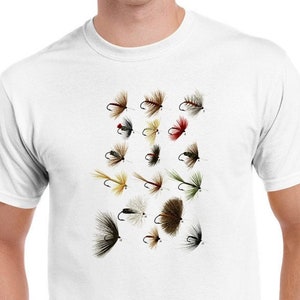 May include: White t-shirt with a graphic print of various fly fishing lures. The lures are depicted in a variety of colors and styles.