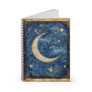 May include: A blue and gold spiral notebook with a crescent moon and stars on the cover. The moon is surrounded by a vintage-style text pattern.