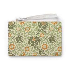 May include: A rectangular clutch with a floral pattern in shades of green, orange, and cream. The design features stylized flowers and foliage. It has a white wrist strap and a gold zipper.