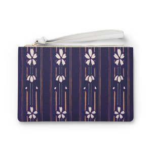 May include: A navy blue clutch with a white zipper and a white floral pattern. The clutch has a white strap.