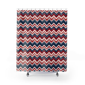 May include: A shower curtain with a red, white, and blue chevron pattern. The pattern is made up of alternating red and blue chevrons with white stars scattered throughout.