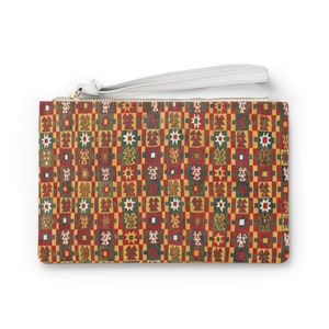 May include: A clutch purse with a white zipper and a white strap. The purse is made of a fabric with a colorful geometric pattern.