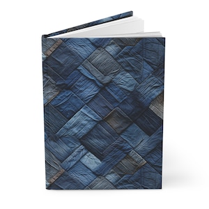 May include: A blue notebook with a cover made of a patchwork of denim fabric.