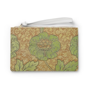 May include: A brown clutch purse with a white zipper and a white strap. The purse has a floral pattern with green leaves and flowers on a brown background.