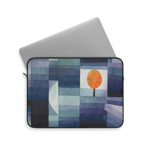May include: Laptop sleeve featuring a watercolor abstract design in shades of blue, purple, and teal. The artwork includes geometric shapes, a crescent moon, and an orange tree. The sleeve has a black zipper and a laptop inside.