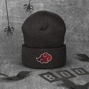 May include: Black beanie with a red cloud design. The beanie is on a gray background with black bats and spiders.