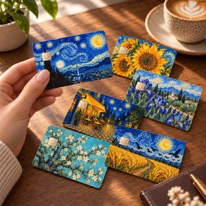 May include: A collection of six rectangular credit cards featuring iconic Vincent van Gogh paintings, including The Starry Night, Sunflowers, Irises, Cafe Terrace at Night, Almond Blossoms, and Wheatfield with Crows, each with a gold chip.