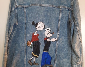 Popeye and Olive Oyl hand painted on a jean jacket.
