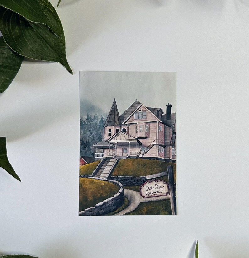 May include: A watercolor painting of a pink house with a white porch and a sign that reads "Pink Place Apartments". The house is surrounded by trees and a stone wall.