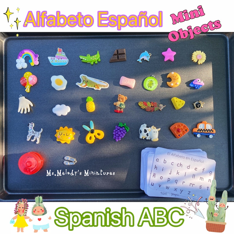 May include: A black tray with colorful miniature objects representing letters of the Spanish alphabet. The tray has the words "Alfabeto Espa&ntilde;ol Mini Objects" and "Ms. Melody's Miniatures" printed on it.  The tray also includes a set of flashcards with the Spanish alphabet printed on them.