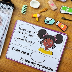 May include: A collection of miniature accessories, including a comb, hair dryer, and a card with the text "What can I use to see my reflection?" and "I can use a to see my reflection." The card features a cartoon girl with curly hair.