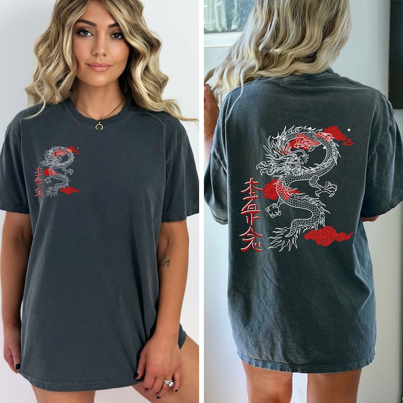 May include: A dark gray oversized t-shirt with a white dragon graphic and red kanji characters that read "本命 天", which translates to "True Love Heaven".