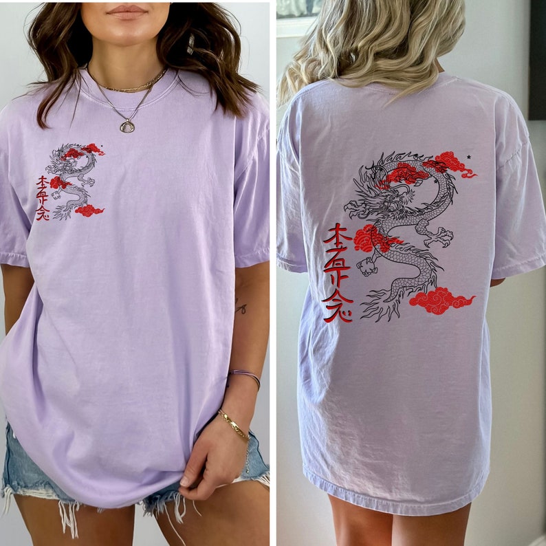 May include: A lavender oversized t-shirt with a black and red dragon graphic and Japanese characters on the back. The front of the shirt has a smaller dragon graphic and Japanese characters on the left side.