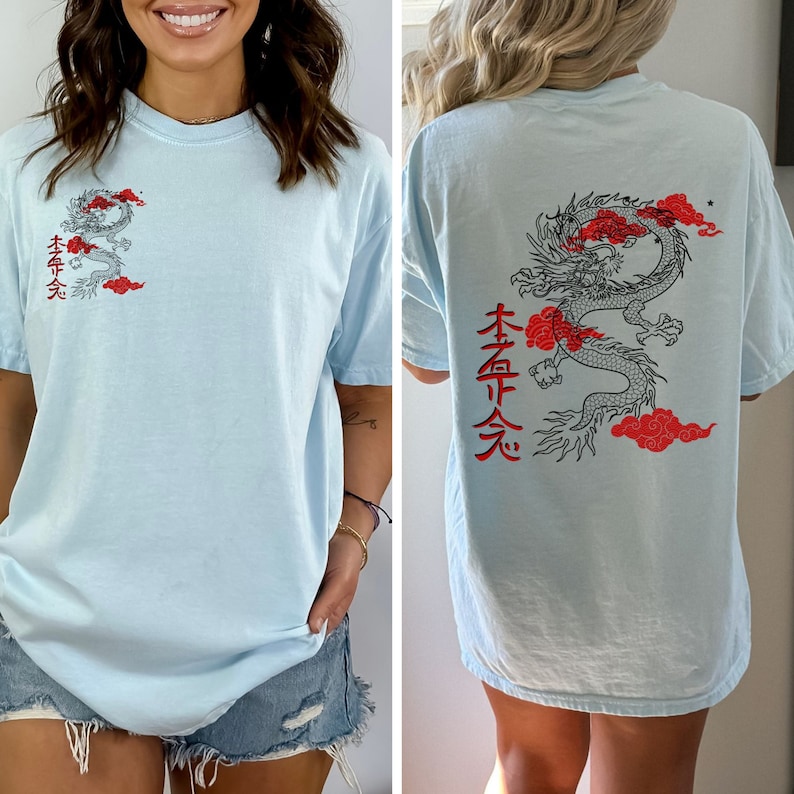 May include: A light blue t-shirt with a black and red dragon graphic and Japanese characters on the front and back. The characters on the front say "本命天" and the characters on the back say "本命天".