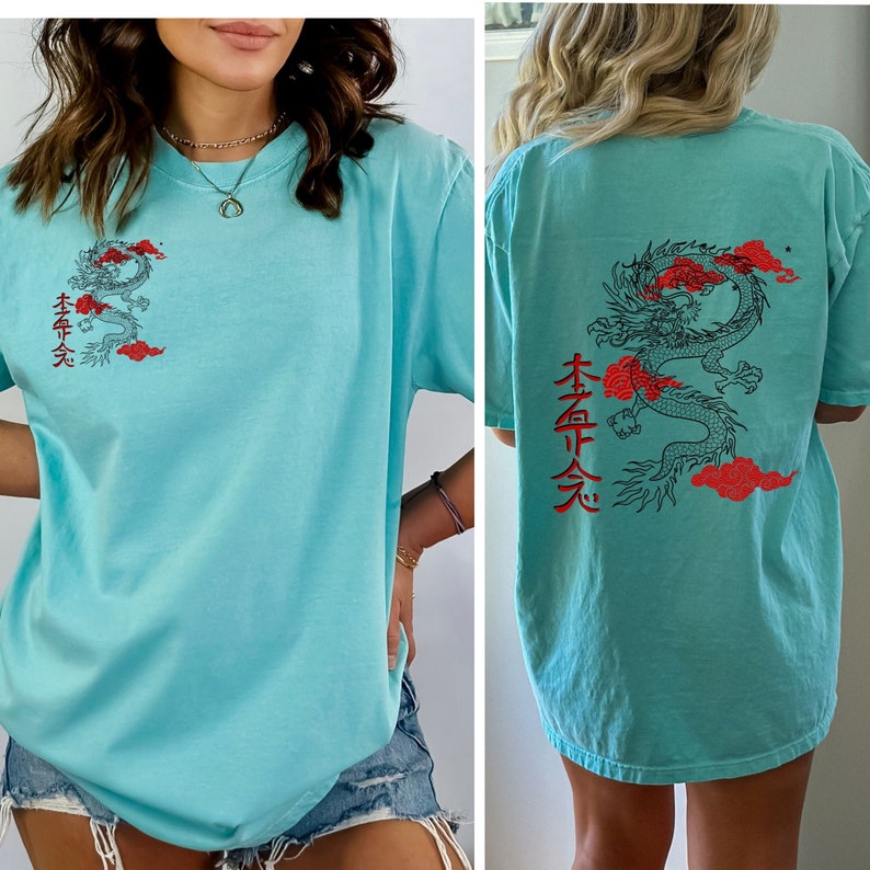 May include: A light blue t-shirt with a red and black dragon graphic and Japanese characters on the back. The front of the shirt has a smaller version of the dragon graphic and Japanese characters.