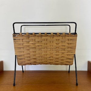 Mid Century magazine rack / newspaper rack made of black metal and wickerwork 60s vintage