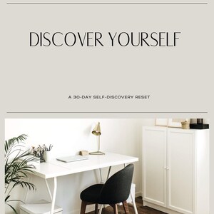 May include: A minimalist workspace featuring a white desk, a black chair, and a gold-toned desk lamp. The text "DISCOVER YOURSELF" and "A 30-DAY SELF-DISCOVERY RESET" are displayed above the workspace.