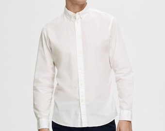 May include: A white long-sleeved button-down shirt with a classic collar and a straight hem.