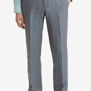 May include: Gray linen pants with a straight leg fit. The pants have a zipper fly and button closure. The model is wearing a light blue shirt.