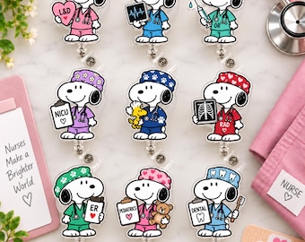 May include: Nine Snoopy character badge reels featuring various medical roles including L&D, ICU, OR, NICU, RAD, ER, Pediatrics, and Dental. Each character wears scrubs and a cap, holding medical items like clipboards, X-rays, or a teddy bear.