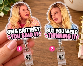 May include: Two acrylic badge reels featuring images of a blonde person. The first reel displays the text OMG BRITTNEY YOU SAID IT. The second reel displays the text BUT YOU WERE THINKING IT. Both reels have a clear plastic clip and metal hardware.