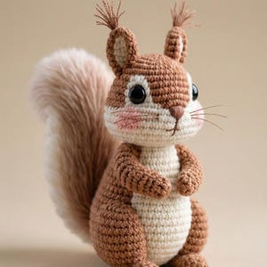May include: A handcrafted crochet squirrel in brown and cream tones, featuring a fluffy tail. The squirrel has black eyes, pink cheeks, and a detailed design, suitable for a nursery or as a decorative piece.