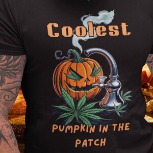 May include: A black t-shirt featuring a graphic of a pumpkin smoking a bong with the text "Coolest Pumpkin in the Patch".