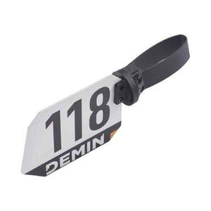 May include: A white plastic tag with the number 118 and the word "DEMIN" printed on it. The tag is attached to a black strap.