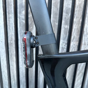 Garmin Varia 300/500 series aero seatpost mounts. Pinarello Dogma F