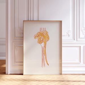 May include: A framed art print featuring a line drawing of a fork with a large portion of spaghetti. The spaghetti is depicted in shades of yellow and orange, and the fork is a reddish-orange color. The artwork is set against a cream-colored background.
