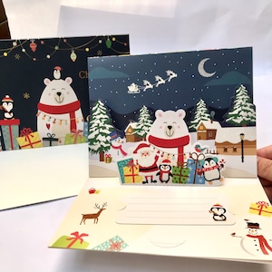 Handgeschöpfte 3D Pop-up Grußkarte Weihnachten in blau glitzernd - Merry Christmas nightbaum Rentierschlitten Schneemann Pinguine Santa Geschenke.