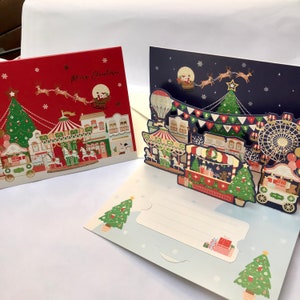 Tarjeta de felicitación navideña 3D emergente de papel hecha a mano con brillo rojo: Papá Noel, árbol de Navidad, reno, trineo, diversión, festival, celebración.