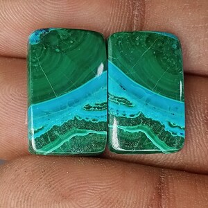 May include: Pair of rectangular green and blue gemstone cabochons. The stones have a swirling pattern of green and blue.