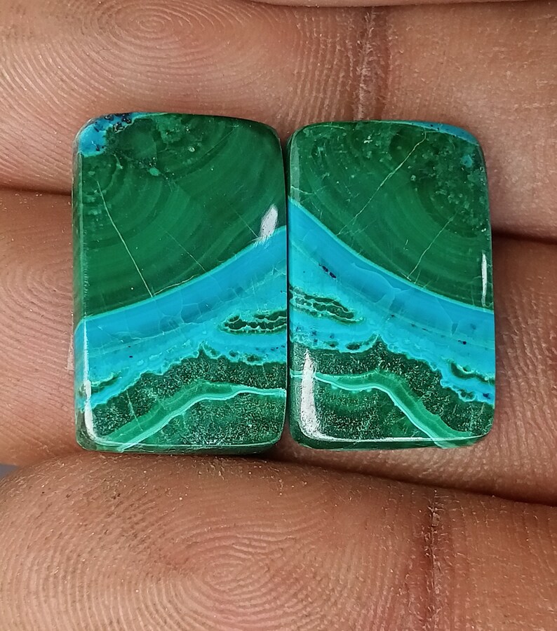 May include: Pair of rectangular green and blue gemstone cabochons. The stones have a swirling pattern of green and blue.