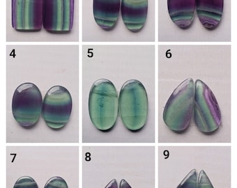 May include: Nine pairs of fluorite cabochons in various shapes and sizes. The cabochons are all green, purple, and white with a striated pattern. The cabochons are numbered 1 through 9.