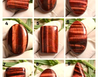 May include: A collection of nine polished red tiger eye gemstones in various shapes. The gemstones display a rich, reddish-brown color with distinctive banding patterns. Each stone is unique, showcasing natural variations in color and texture, perfect for jewelry making.