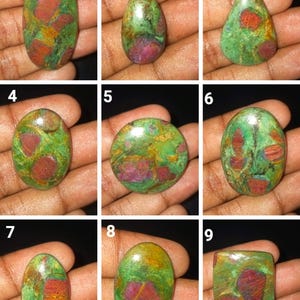May include: Nine cabochon cut green, red, and brown stones with a variety of shapes, including oval, teardrop, and square.