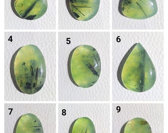 May include: Nine green gemstone cabochons with black inclusions, numbered 1 through 9. The cabochons are various shapes, including oval, teardrop, and triangular.