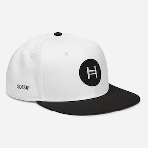 May include: White and black baseball cap with a black circle and a white letter H in the centre. The cap has the word "Gossip" printed on the front.