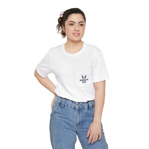 May include: White t-shirt with a pocket featuring a black and white bunny graphic with the text "BOHICA" on the pocket.
