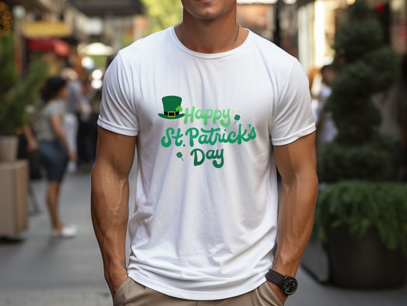 May include: White t-shirt featuring a green shamrock and a leprechaun hat graphic. The text "Happy St. Patrick's Day" is written in green cursive.