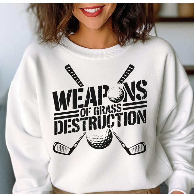 May include: White sweatshirt with black text that reads "Weapons of Grass Destruction" with a golf club and golf ball graphic.