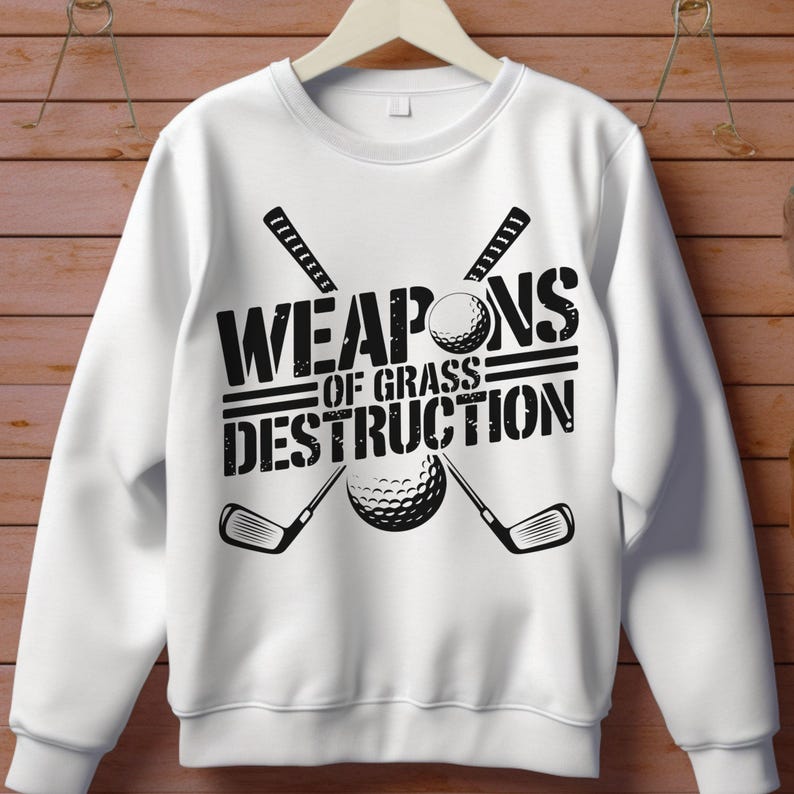 May include: White sweatshirt with black text that reads "Weapons of Grass Destruction" with a golf club and golf ball graphic.