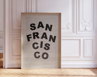 May include: A framed print with the text "SAN FRANCISCO" in black letters on a beige background.