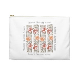 May include: White zippered pouch with a repeating pattern of stylized flowers in shades of orange and red. The words "Thankful Grateful Blessed" are repeated around the border of the design.