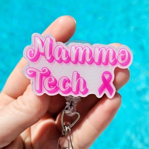 May include: Pink and white badge holder with the text "Mammo Tech" and a pink ribbon.