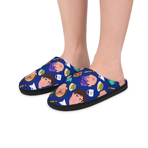 May include: A pair of blue and black slippers featuring a pattern of a man's face, a coffee cup, and a pretzel. The slippers are made from soft, comfortable material and are ideal for relaxing at home.