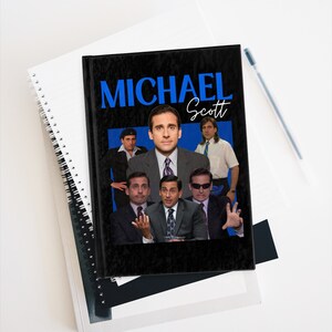 May include: A black notebook featuring a collage of images of Michael Scott from the TV show "The Office". The title "MICHAEL Scott" is written in blue letters on the front cover.