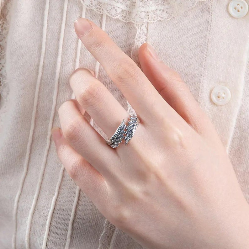 An adjustable silver ring that has two small wings on each side of the band. The wings are detailed and symbolize protection and guidance. Can be customized with a name engraved on the inside of the band. It comes with a meaningful message card.